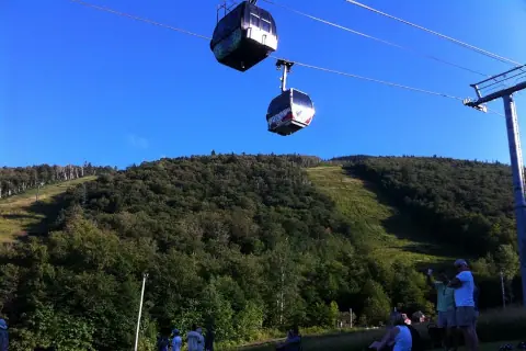 Killington Mountain in the summer, with its lifts, and people enjoying the sun.