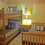 The upper left bedroom has a bunk bed and twin bed and sleeps three. Left Unit: Upper Left Bedroom