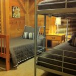 The upper middle bedroom has a bunk bed and twin bed and sleeps three. Left Unit: Upper Middle Bedroom