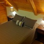 The upper right bedroom has a queen bed and sleeps two. Left Unit: Upper Right Bedroom