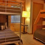 The downstairs bedroom has a twin over full bunk bed and twin bunk bed and sleeps four to five. Right Unit: Lower Bedroom