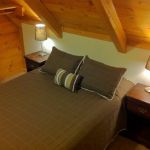 The upper right bedroom has a queen bed and sleeps two. Left Unit: Upper Right Bedroom