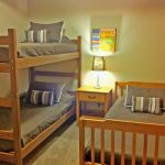 The upper left bedroom has a bunk bed and twin bed and sleeps three. Left Unit: Upper Left Bedroom