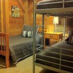 The upper middle bedroom has a bunk bed and twin bed and sleeps three. Left Unit: Upper Middle Bedroom